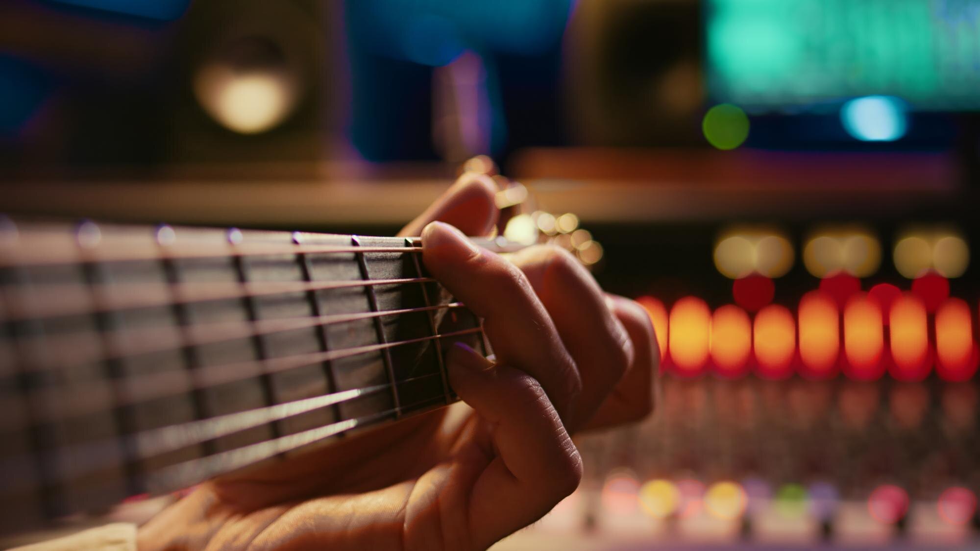 artist-composer-creating-new-song-his-electro-guitar-studio_482257-122270